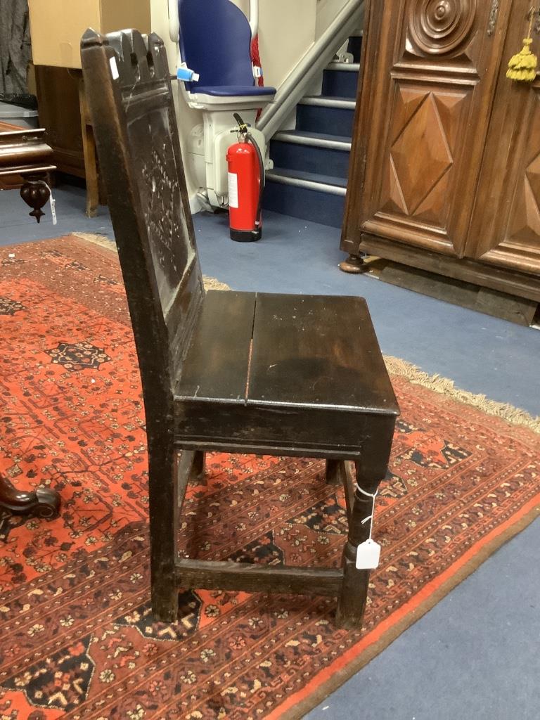 A 17th century and later oak panelled back stool with carved lozenge decoration, width 47cm, depth 38cm, height 91cm